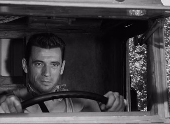 Movie still from “The Wages of Fear” (1953), directed by Henri-Georges Clouzot – A black and white photo of a man driving a truck; Close Up shot, Low angle