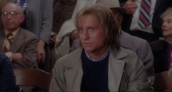 Movie still from “The War of the Roses” (1989), directed by Danny DeVito – A person with long hair; Close Up shot, High angle