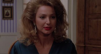 Movie still from “The War of the Roses” (1989), directed by Danny DeVito – A person with long hair; Close Up shot, Over the shoulder angle