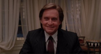 Movie still from “The War of the Roses” (1989), directed by Danny DeVito – A person wearing a suit and tie; Close Up shot, Low angle