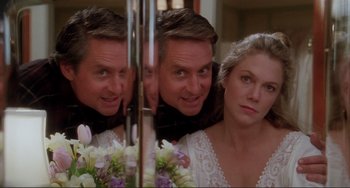 Movie still from “The War of the Roses” (1989), directed by Danny DeVito – A man and a woman looking at each other in a mirror; Close Up shot, Low angle