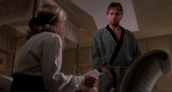 Movie still from “The War of the Roses” (1989), directed by Danny DeVito – A man and a woman in a room; Medium shot, Over the shoulder angle