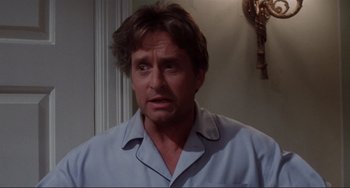 Movie still from “The War of the Roses” (1989), directed by Danny DeVito – A person wearing a shirt; Close Up shot, Low angle