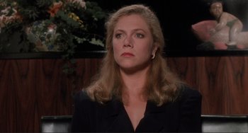 Movie still from “The War of the Roses” (1989), directed by Danny DeVito – A person with long hair; Close Up shot, Over the shoulder angle