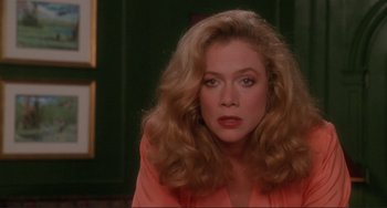 Movie still from “The War of the Roses” (1989), directed by Danny DeVito – A person with long blonde hair; Close Up shot, Over the shoulder angle