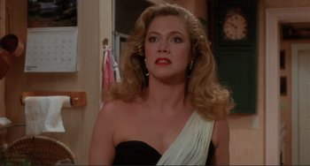 Movie still from “The War of the Roses” (1989), directed by Danny DeVito – A person wearing a dress; Close Up shot, Over the shoulder angle