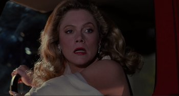 Movie still from “The War of the Roses” (1989), directed by Danny DeVito – A person with long hair; Close Up shot, Low angle