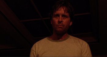 Movie still from “The War of the Roses” (1989), directed by Danny DeVito – A person wearing a white t - shirt; Close Up shot, Low angle