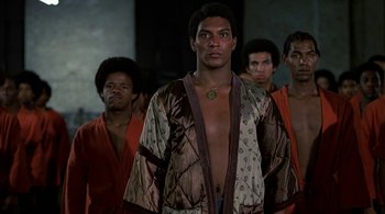 Movie still from “The Warriors” (1979), directed by Walter Hill – A group of men standing next to each other; Medium shot, Low angle