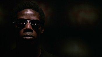 Movie still from “The Warriors” (1979), directed by Walter Hill – A person wearing sunglasses; Close Up shot, Low angle