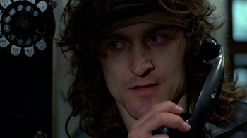 Movie still from “The Warriors” (1979), directed by Walter Hill – A person holding a cell phone; Close Up shot, Low angle