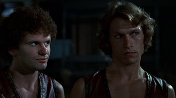 Movie still from “The Warriors” (1979), directed by Walter Hill – Two men standing next to each other in a dark room; Close Up shot, Low angle