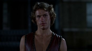 Movie still from “The Warriors” (1979), directed by Walter Hill – A man with long hair wearing a leather vest; Close Up shot, Low angle