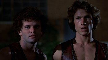 Movie still from “The Warriors” (1979), directed by Walter Hill – A couple of men standing next to each other; Close Up shot, Low angle