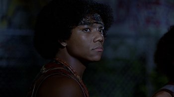Movie still from “The Warriors” (1979), directed by Walter Hill – A young man with an afro is looking up; Close Up shot, Low angle
