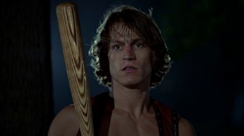 Movie still from “The Warriors” (1979), directed by Walter Hill – A man holding a wooden baseball bat in his hands; Close Up shot, Low angle
