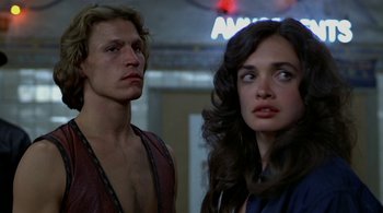 Movie still from “The Warriors” (1979), directed by Walter Hill – A man and a woman standing next to each other; Close Up shot, Low angle