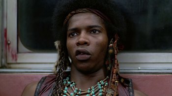 Movie still from “The Warriors” (1979), directed by Walter Hill – A person wearing a necklace; Close Up shot, Low angle