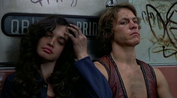 Movie still from “The Warriors” (1979), directed by Walter Hill – A man and a woman sitting next to each other; Close Up shot, Low angle