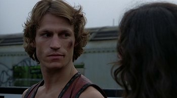 Movie still from “The Warriors” (1979), directed by Walter Hill – A man with a bruised face looking at a woman with long dark hair; Close Up shot, Over the shoulder angle