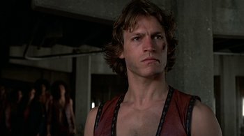 Movie still from “The Warriors” (1979), directed by Walter Hill – A person with long hair; Close Up shot, Low angle