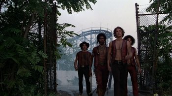 Movie still from “The Warriors” (1979), directed by Walter Hill – A group of people walking down a street; Wide shot, Low angle