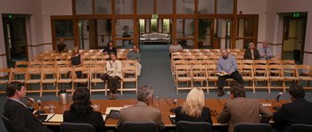 Movie still from “The Watch” (2012), directed by Akiva Schaffer – A group of people sitting in a room with chairs; Wide shot, High angle