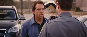 Movie still from “The Watch” (2012), directed by Akiva Schaffer – A man standing next to another man in a parking lot; Close Up shot, Over the shoulder angle