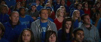 Movie still from “The Watch” (2012), directed by Akiva Schaffer – A group of people sitting in a room watching something; Medium shot, High angle