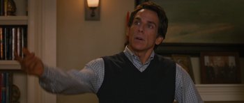 Movie still from “The Watch” (2012), directed by Akiva Schaffer – A man in a vest is looking up at the ceiling; Medium shot, Over the shoulder angle