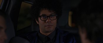 Movie still from “The Watch” (2012), directed by Akiva Schaffer – A person wearing glasses and a jacket; Close Up shot, Over the shoulder angle