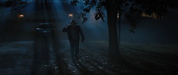 Movie still from “The Watch” (2012), directed by Akiva Schaffer – A man walking in the dark near a tree at night; Wide shot, Low angle