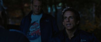 Movie still from “The Watch” (2012), directed by Akiva Schaffer – A man standing next to another man in a dark room; Close Up shot, Over the shoulder angle