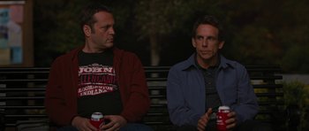 Movie still from “The Watch” (2012), directed by Akiva Schaffer – A couple of men sitting on top of a wooden bench; Medium shot, Over the shoulder angle