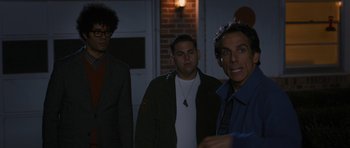 Movie still from “The Watch” (2012), directed by Akiva Schaffer – A group of men standing next to each other in front of a brick wall; Medium shot, Over the shoulder angle