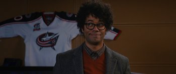 Movie still from “The Watch” (2012), directed by Akiva Schaffer – A man in a jacket and a red shirt; Close Up shot, Over the shoulder angle