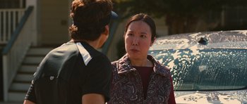 Movie still from “The Watch” (2012), directed by Akiva Schaffer – A woman talking to another woman in front of a parked car; Close Up shot, Over the shoulder angle