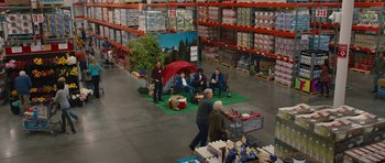 Movie still from “The Watch” (2012), directed by Akiva Schaffer – A group of people sitting around a store floor; Extreme Wide shot, High angle