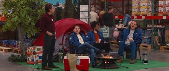 Movie still from “The Watch” (2012), directed by Akiva Schaffer – A group of people sitting around a fire pit; Wide shot, Over the shoulder angle