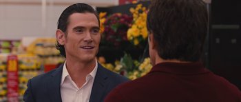 Movie still from “The Watch” (2012), directed by Akiva Schaffer – A man talking to another man in front of flowers; Close Up shot, Over the shoulder angle