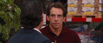 Movie still from “The Watch” (2012), directed by Akiva Schaffer – A man in a red shirt is talking to another man in a black suit; Close Up shot, Over the shoulder angle