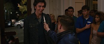 Movie still from “The Watch” (2012), directed by Akiva Schaffer – A man holding a pair of scissors in his hand; Medium shot, Over the shoulder angle