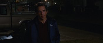 Movie still from “The Watch” (2012), directed by Akiva Schaffer – Ben stiller in a blue jacket standing in the dark; Medium shot, Over the shoulder angle