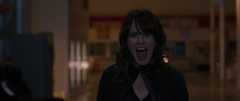 Movie still from “The Watch” (2012), directed by Akiva Schaffer – A woman with her mouth wide open in the dark; Close Up shot, Overhead angle