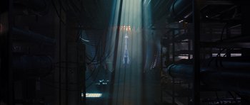 Movie still from “The Watch” (2012), directed by Akiva Schaffer – A light shining on a building in the middle of the night; Extreme Wide shot, High angle