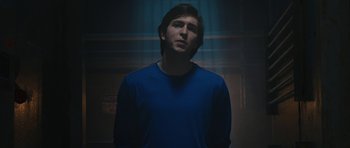 Movie still from “The Watch” (2012), directed by Akiva Schaffer – A man in a blue shirt is standing in the dark; Medium shot, Low angle