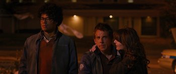 Movie still from “The Watch” (2012), directed by Akiva Schaffer – A man and a woman standing next to each other in front of another man; Medium shot, Over the shoulder angle