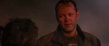 Movie still from “The Watch” (2012), directed by Akiva Schaffer – A person wearing a brown jacket; Close Up shot, Over the shoulder angle
