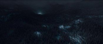 Movie still from “The Way Back” (2010), directed by Peter Weir – A view of a dark forest from a helicopter at night; Extreme Wide shot, High angle