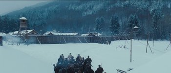 Movie still from “The Way Back” (2010), directed by Peter Weir – A group of people standing on top of a snow covered slope; Extreme Wide shot, High angle